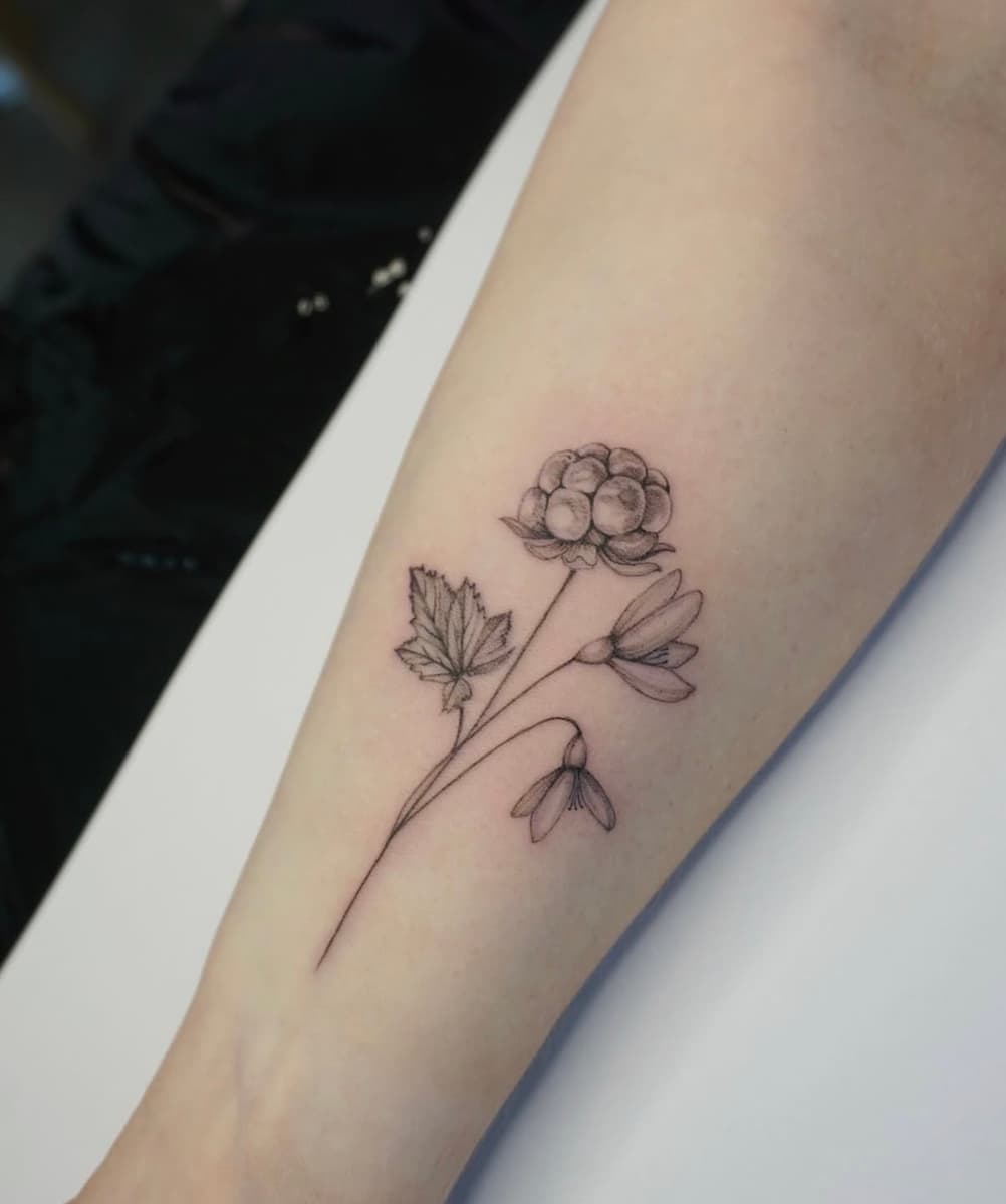 Black and grey swallow bird tattoos in flight on the forearm