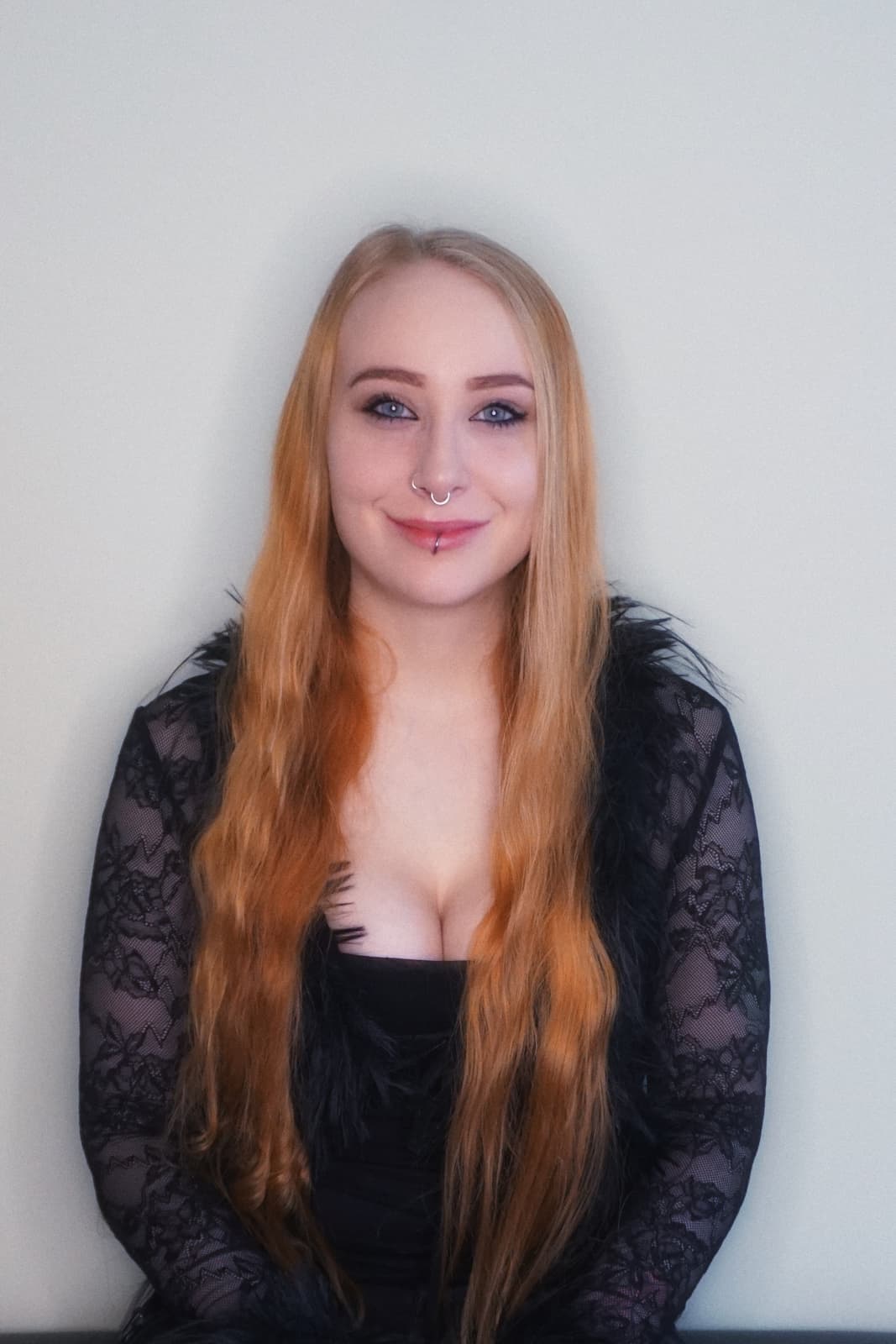 Smiling woman posing in a bright studio
